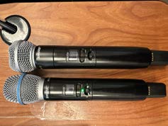 Room 207: Two Shure SLXD2 wireless handheld microphones