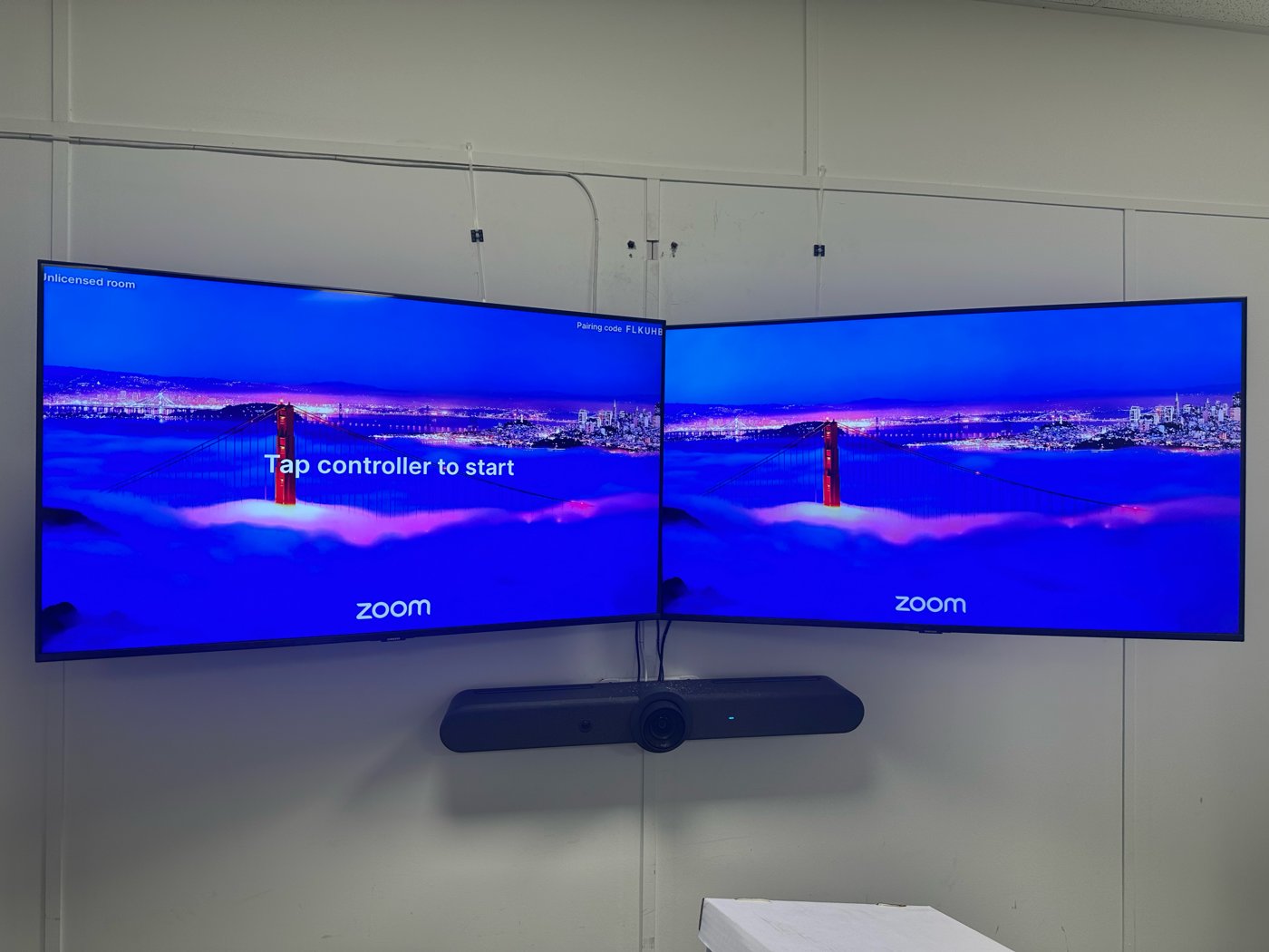 A36: Dual wall displays with the Logitech camera bar underneath